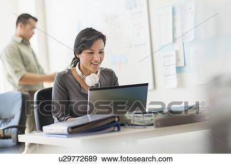 Stock Photo - Two people working in office. Fotosearch