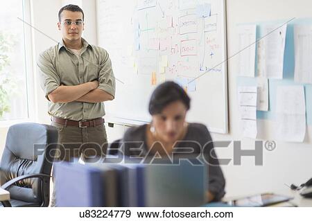 Two people working in office View Large Photo Image Stock Photo - Two people working in office. Fotosearch