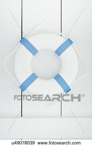 Stock Photo - White lifebelt hanging on white wall. Fotosearch