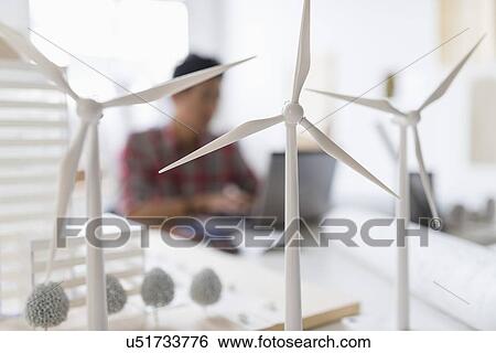 Wind turbine models on desk, architect in background View Large Photo Image Stock Photograph - Wind turbine models on desk, architect in background. Fotosearch