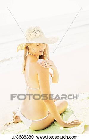 Woman applying sun protector View Large Photo Image Stock Image - Woman applying sun protector. Fotosearch