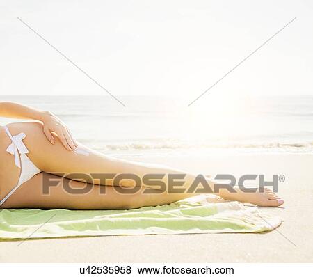 Woman applying sun protector View Large Photo Image Stock Photo - Woman applying sun protector. Fotosearch
