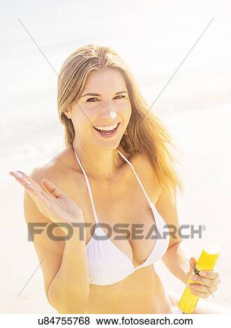 Woman applying sun protector View Large Photo Image Stock Photo - Woman applying sun protector. Fotosearch