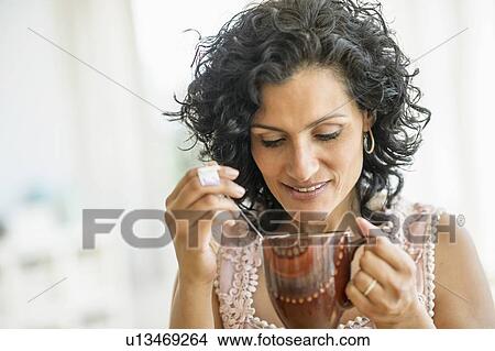 Woman enjoying her tea View Large Photo Image Picture - Woman enjoying her tea. Fotosearch