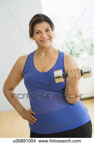 Woman exercising at gym View Large Photo Image Picture - Woman exercising at gym. Fotosearch