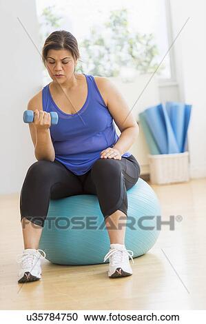Woman exercising at gym View Large Photo Image Stock Image - Woman exercising at gym. Fotosearch