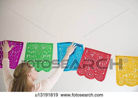 Woman hanging decoration View Large Photo Image Stock Photo - Woman hanging decoration. Fotosearch