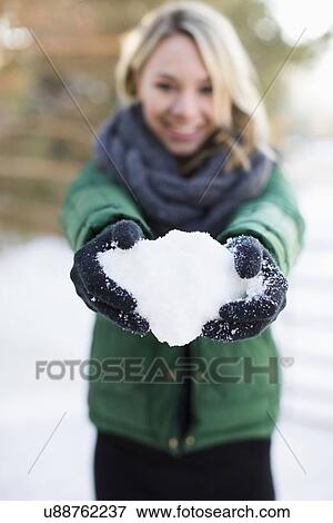 Stock Photo - Woman holding snowball. Fotosearch