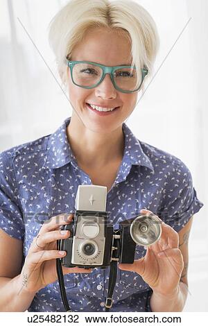 Woman holding vintage camera View Large Photo Image Stock Image - Woman holding vintage camera. Fotosearch