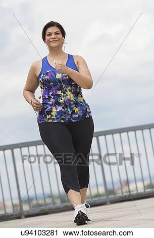 Woman jogging on bridge View Large Photo Image Stock Image - Woman jogging on bridge. Fotosearch