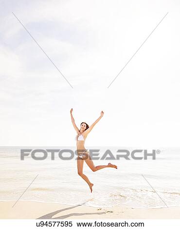 Woman jumping on beach View Large Photo Image Stock Photography - Woman jumping on beach. Fotosearch