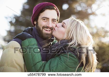 Woman kissing man's cheek View Large Photo Image Stock Photo - Woman kissing man's cheek. Fotosearch