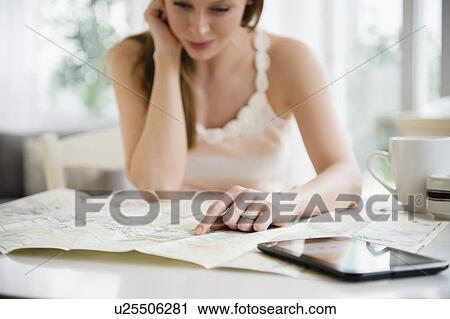 Stock Image - Woman making travel plans. Fotosearch