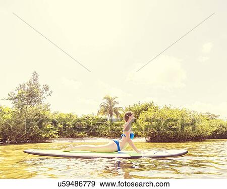 Woman on paddle board View Large Photo Image Stock Photo - Woman on paddle board. Fotosearch