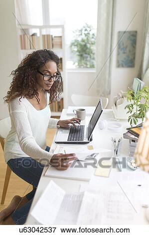 Woman paying bills via internet View Large Photo Image Stock Photo - Woman paying bills via internet. Fotosearch