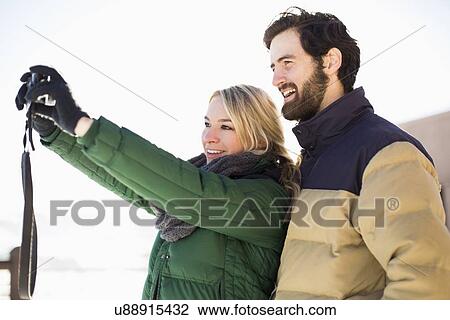 Woman photographing herself and man View Large Photo Image Stock Image - Woman photographing herself and man. Fotosearch
