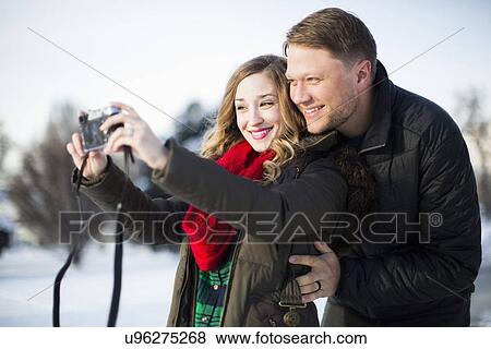 Woman photographing herself and man View Large Photo Image Stock Photo - Woman photographing herself and man. Fotosearch