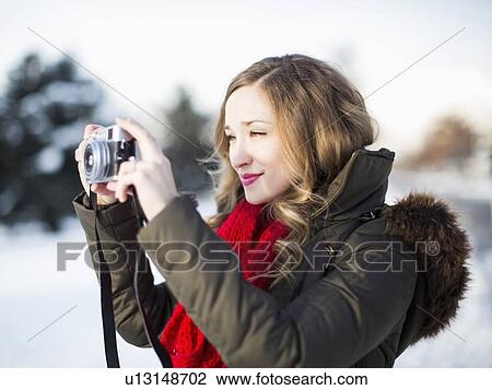 Woman photographing winter landscape View Large Photo Image Stock Image - Woman photographing winter landscape. Fotosearch