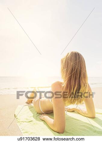 Woman relaxing on beach View Large Photo Image Stock Photo - Woman relaxing on beach. Fotosearch