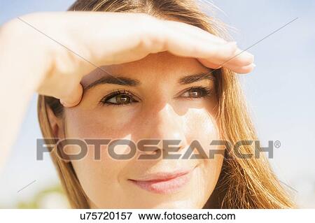 Woman shielding eyes View Large Photo Image Stock Photo - Woman shielding eyes. Fotosearch
