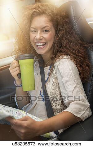 Woman sitting in car with map and disposable cup View Large Photo Image Stock Image - Woman sitting in car with map and disposable cup. Fotosearch