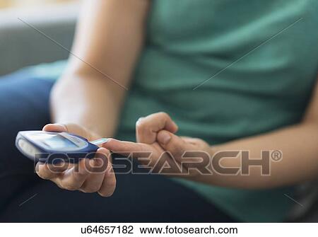 Woman sitting on sofa with mobile phone View Large Photo Image Stock Image - Woman sitting on sofa with mobile phone. Fotosearch