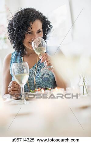 Stock Photography - Woman tasting wine in restaurant. Fotosearch