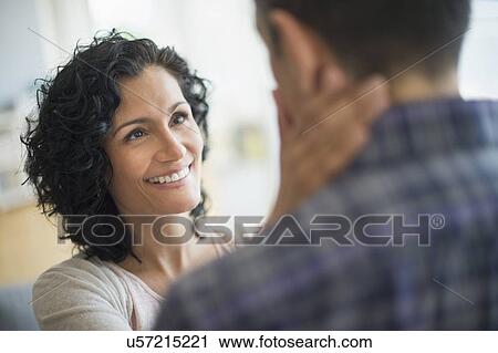 Stock Image - Woman touching man's neck. Fotosearch