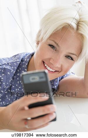 Woman using cell phone View Large Photo Image Picture - Woman using cell phone. Fotosearch