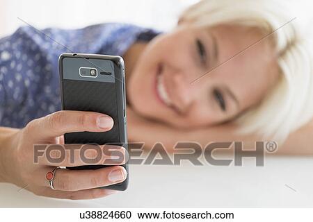 Woman using cell phone View Large Photo Image Stock Image - Woman using cell phone. Fotosearch