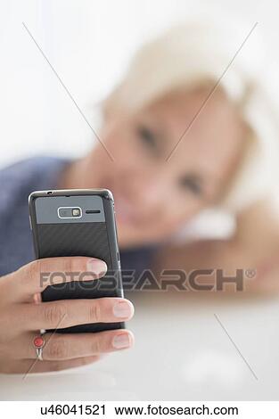 Woman using cell phone View Large Photo Image Stock Image - Woman using cell phone. Fotosearch