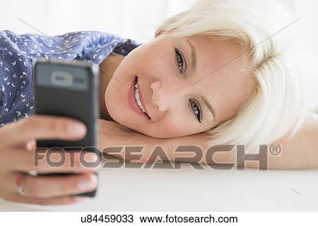 Woman using cell phone View Large Photo Image Stock Image - Woman using cell phone. Fotosearch