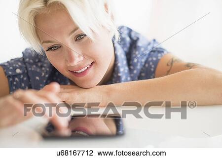 Woman using digital tablet View Large Photo Image Stock Image - Woman using digital tablet. Fotosearch