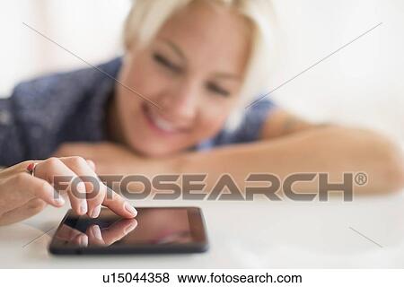 Stock Photo - Woman using digital tablet. Fotosearch