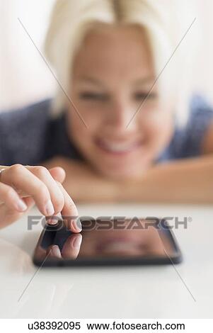 Woman using digital tablet View Large Photo Image Stock Photography - Woman using digital tablet. Fotosearch