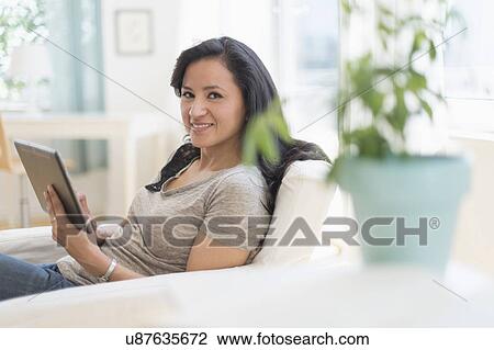Stock Image - Woman with digital tablet. Fotosearch