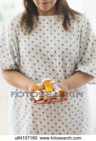 Woman with pill bottles in hands View Large Photo Image Stock Image - Woman with pill bottles in hands. Fotosearch