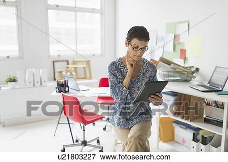 Stock Photo - Woman working in home office. Fotosearch
