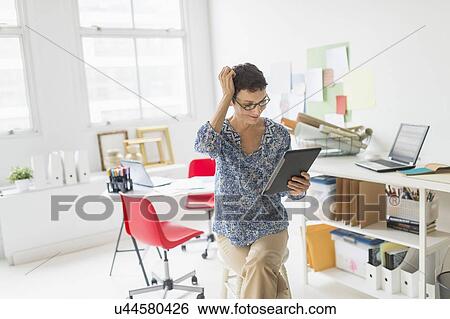 Woman working in home office View Large Photo Image Stock Photograph - Woman working in home office. Fotosearch