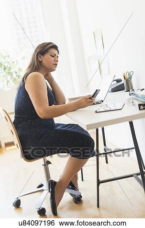 Woman working in home office View Large Photo Image Stock Photograph - Woman working in home office. Fotosearch
