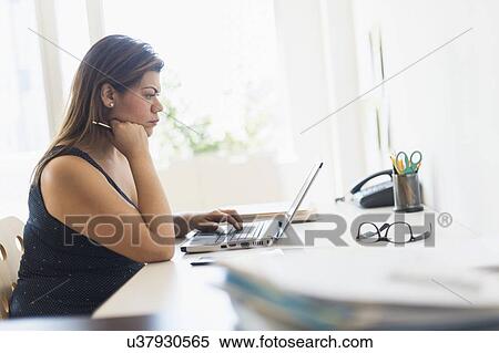 Woman working in home office View Large Photo Image Stock Photography - Woman working in home office. Fotosearch