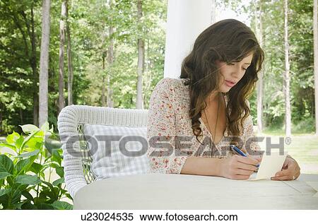 Woman writing letter on porch View Large Photo Image Stock Photography - Woman writing letter on porch. Fotosearch