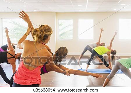 Picture - Women exercising yoga. Fotosearch