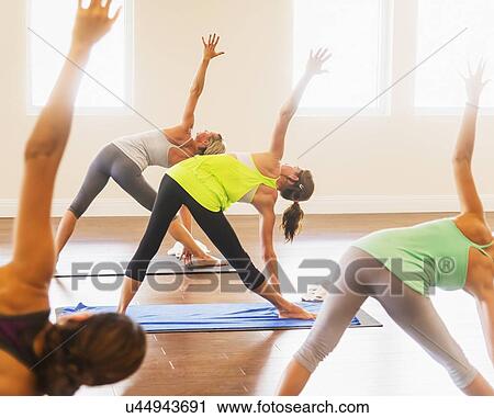 Stock Image - Women exercising yoga. Fotosearch