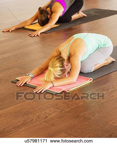 Stock Image - Women exercising yoga. Fotosearch