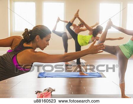 Stock Image - Women exercising yoga. Fotosearch