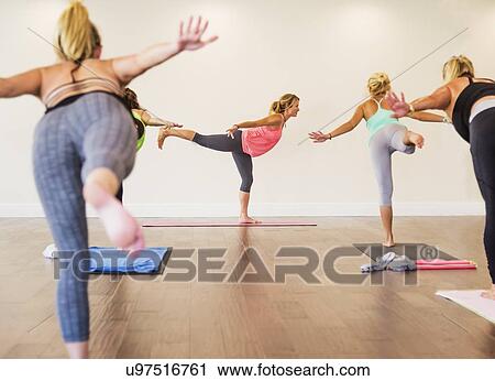 Stock Image - Women exercising yoga. Fotosearch