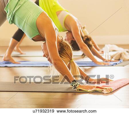 Stock Photo - Women exercising yoga. Fotosearch