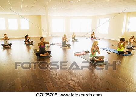 Stock Photography - Women exercising yoga. Fotosearch