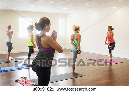 Stock Photography - Women exercising yoga. Fotosearch